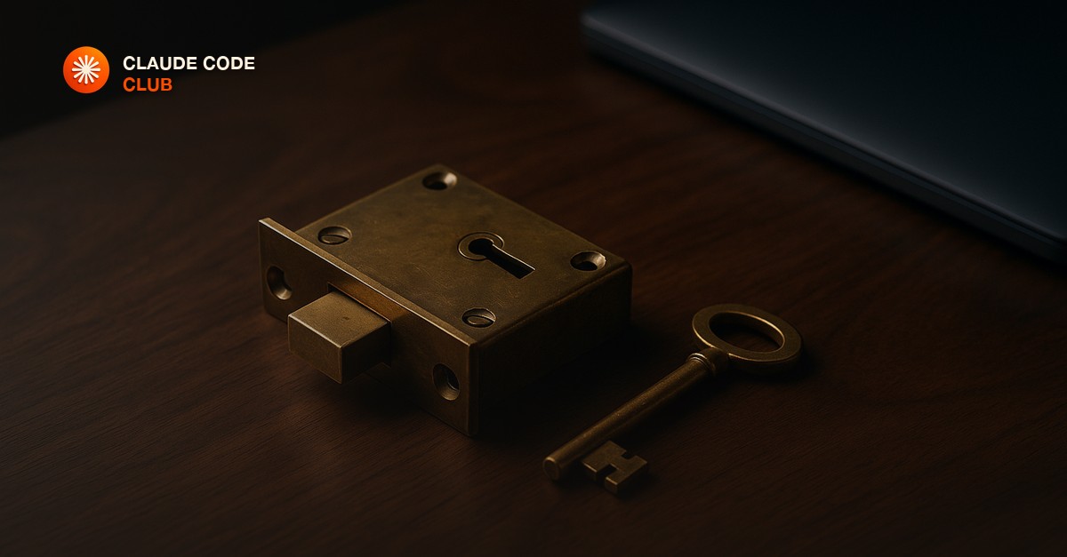 A heavy brass door lock and a single key resting on a clean walnut desk beside a closed laptop