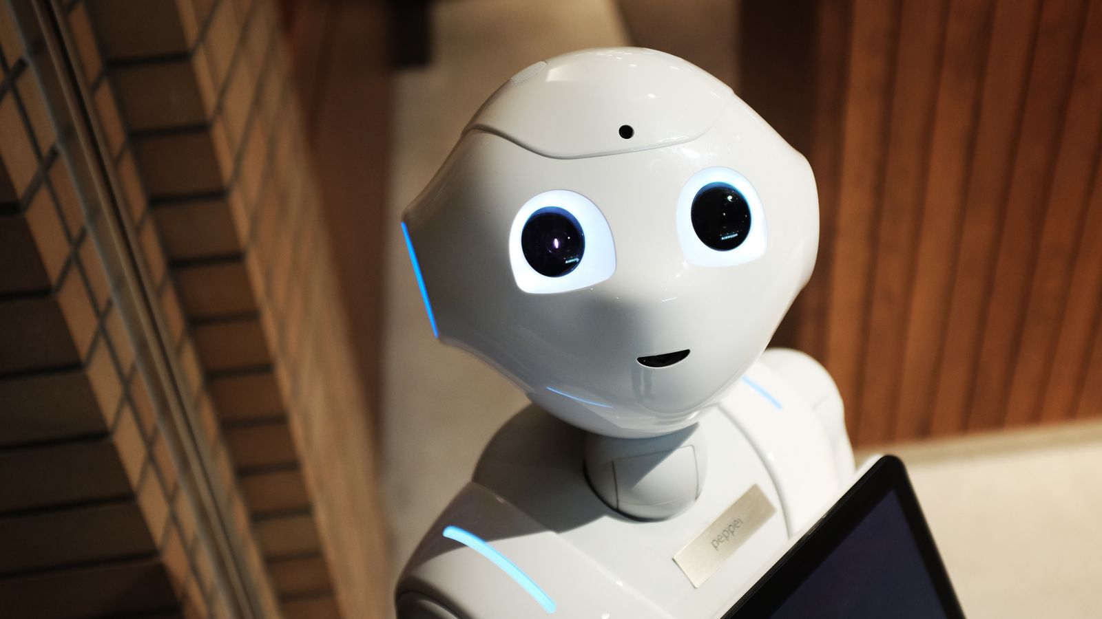 A friendly white humanoid robot, representing building your first AI agent