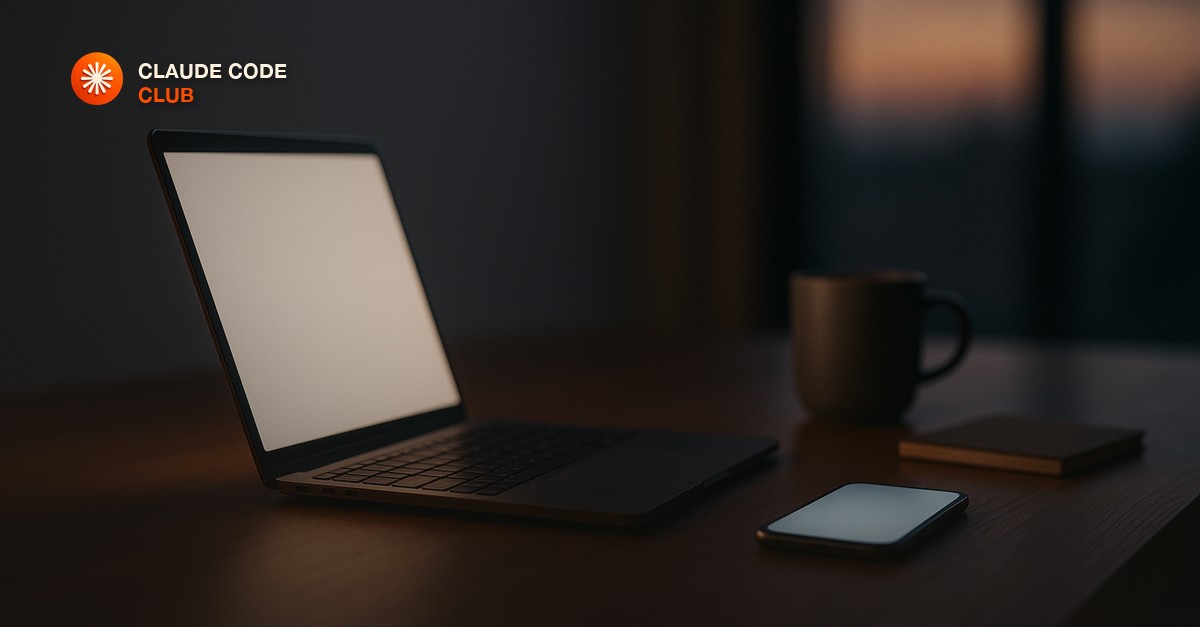 A laptop glowing softly on a wooden desk at dusk beside a smartphone lying face up, a coffee cup and notebook nearby, calm home-office mood