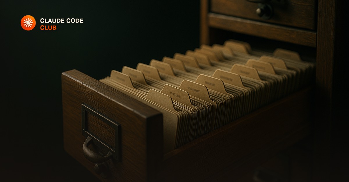 A wooden card catalog drawer pulled open showing neat labeled dividers, lit in moody directional light with dark green and brass tones