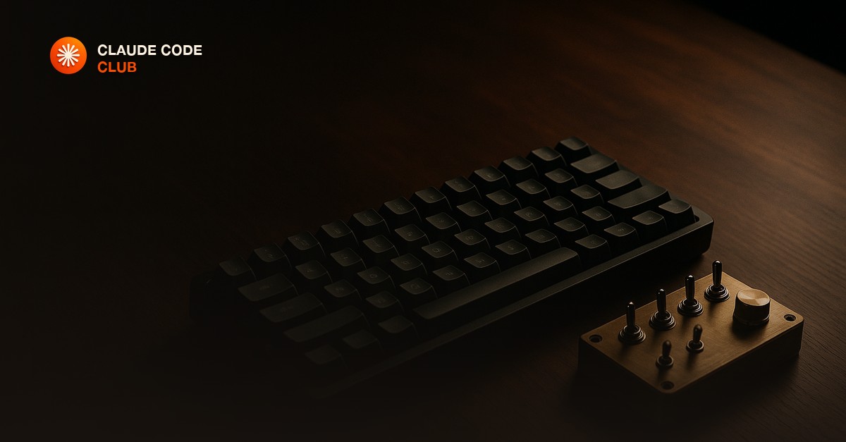 A mechanical keyboard beside a small brass control panel with toggle switches and a dial on a dark walnut desk