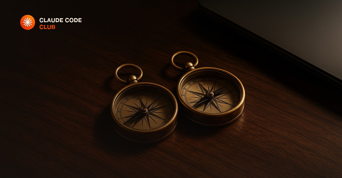 Two brass compasses side by side on a dark walnut desk beside a closed laptop