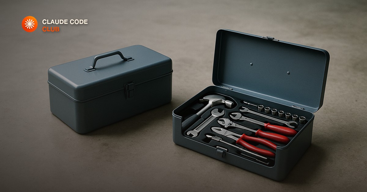 Two identical metal toolboxes side by side on a bare concrete floor, one open showing neatly organized hand tools