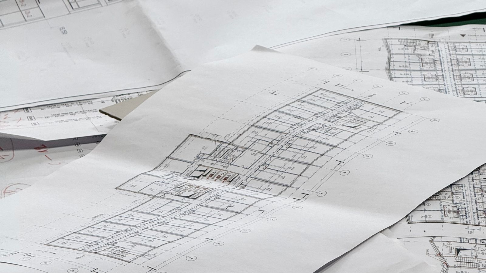 Architectural blueprints spread across a desk, representing reusable project templates