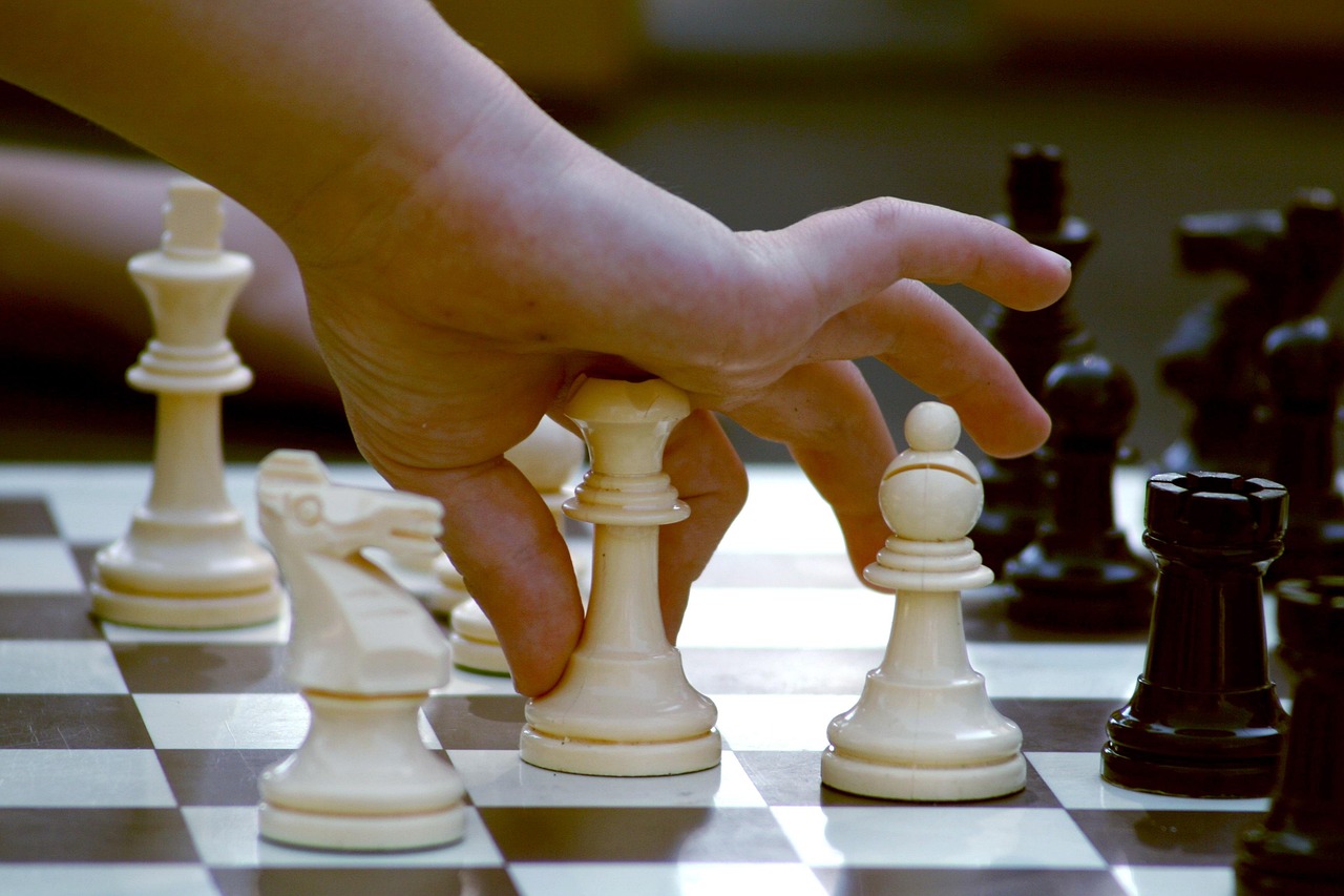 Chess board mid-game with two opposing pieces facing each other - a strategy and decision metaphor