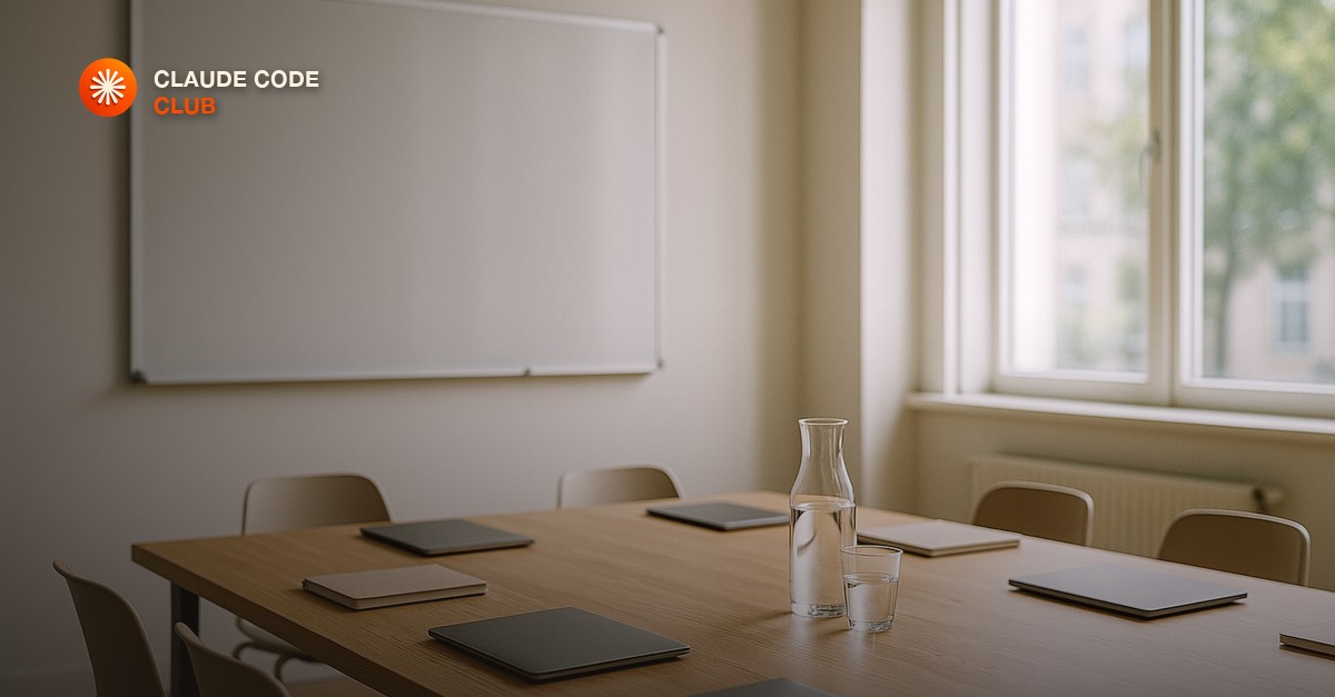 A bright modern training room with an empty whiteboard, a long oak table with a few closed laptops and notebooks, a glass carafe of water and tumblers, soft daylight through tall windows