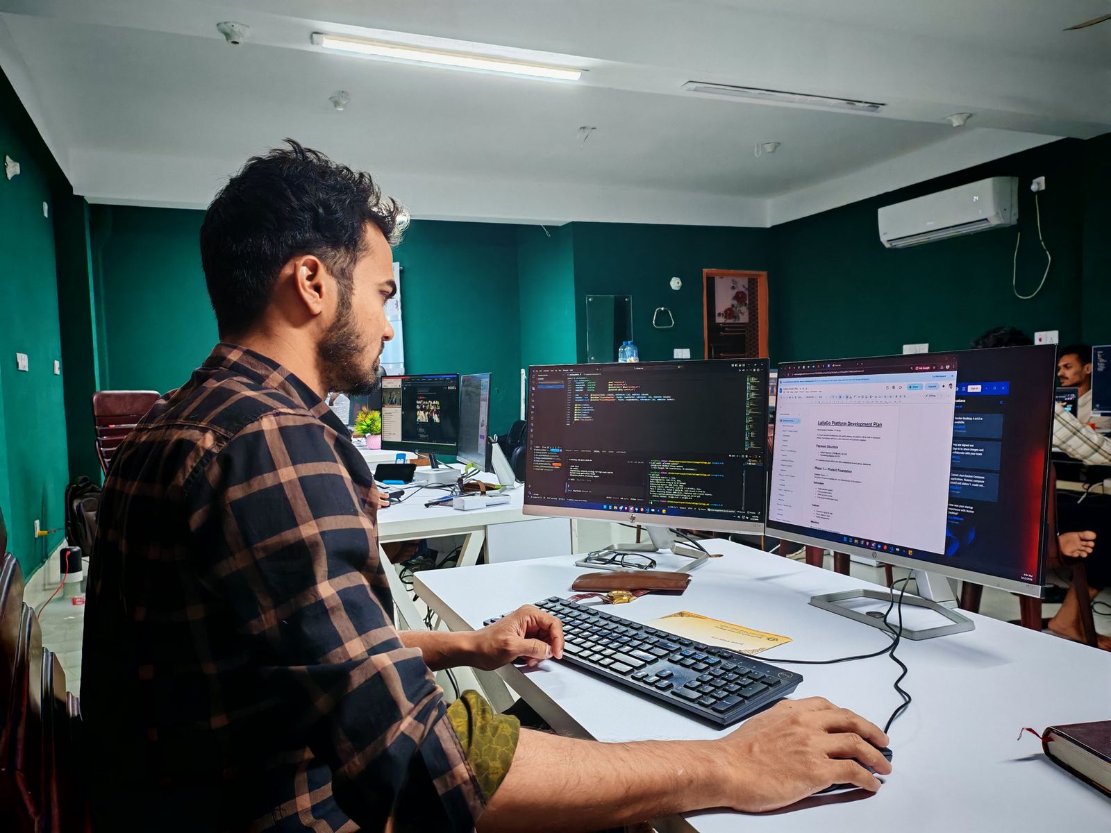 A developer team collaborating around screens